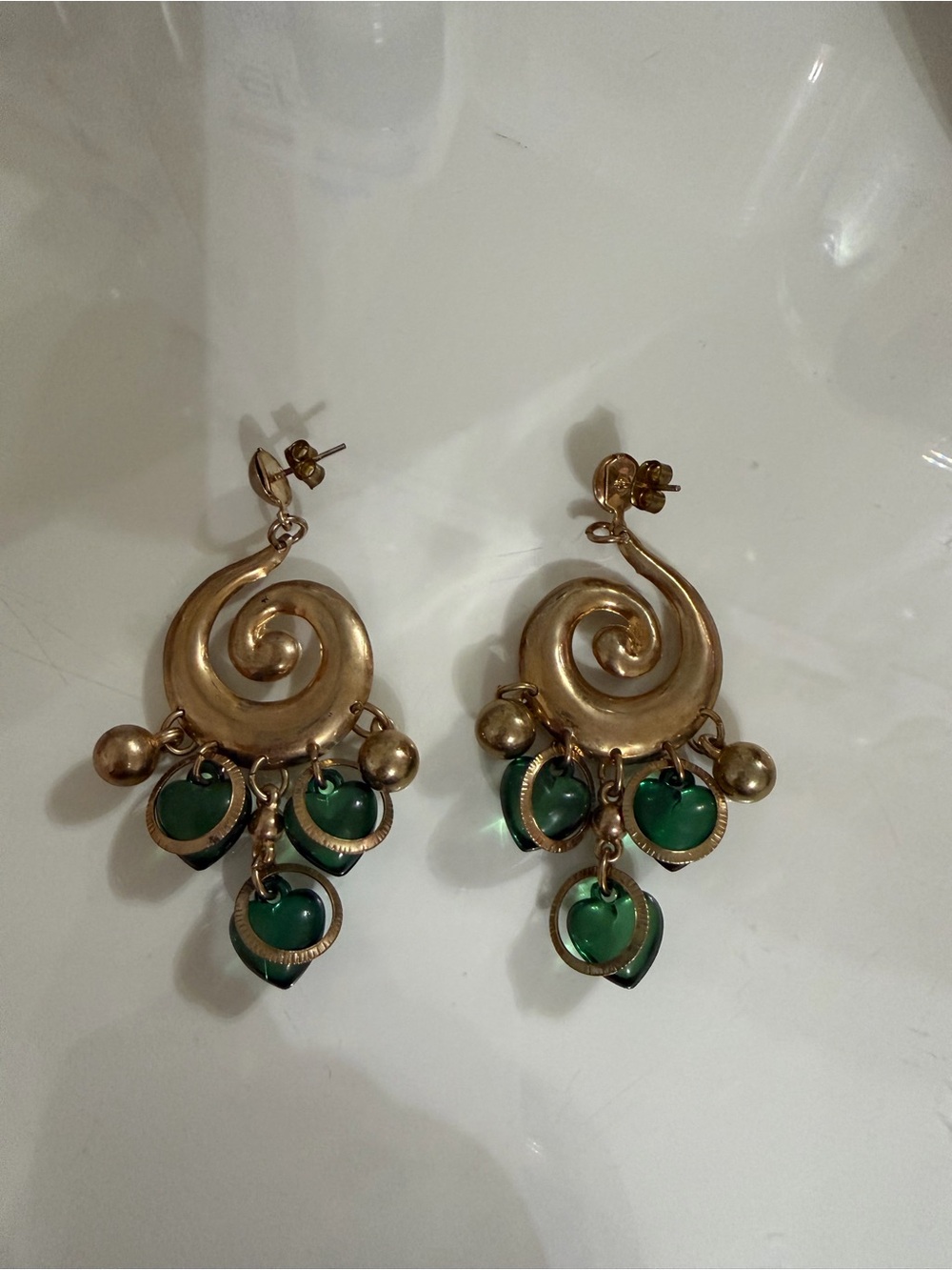 Gold Swirl Drop Earrings with Green Heart Charms